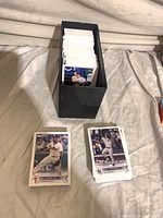 Topps baseball trading cards in black storage box with additional stack