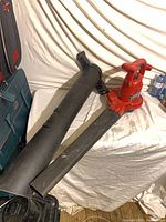 Leaf blower with both nozzles laid on table