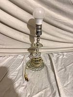 Full view of lamp showing glass segments, metal socket and bulb