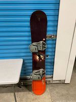 Full view of snowboard front with mounted bindings
