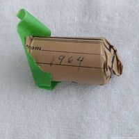 Brown paper-wrapped roll of 1964 Canadian half dollars