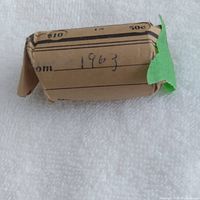 Paper coin roll labeled $10 in 50c 1963