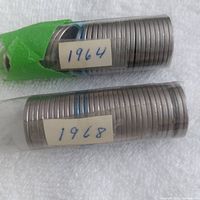 Two partially wrapped rolls of Canadian nickels labeled 1964 and 1968