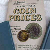 Cover of Edmund's United States Coin Prices with partial views of two Canadian catalogues