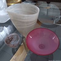 Frosted vase, pink candy dish, purple trinket bowl on glass table
