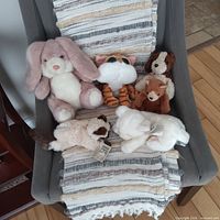 All six plush animals on chair overview