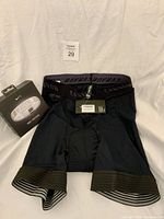 Canyon bike shorts front view with Nike FuelBand box