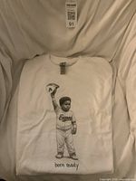 Folded white Gildan Heavy Cotton T-shirt with graphic visible