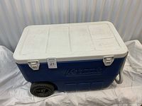 Cooler closed showing wheels and handle