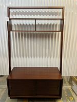 Full view of TV stand showing cabinet and upper shelving