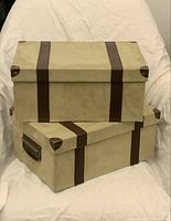Stacked sage green storage boxes showing size difference and brown faux leather straps