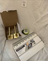 Lot overview showing door handles, laser level, slatwall samples