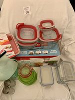 Group shot of all containers including collapsible, green glass, rectangular glass, stainless-steel lid jars, silicone bottle and retail box