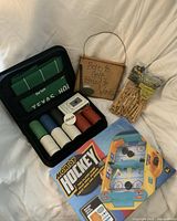 Full lot including Montoya hockey game box, poker set case, golf sign and bag of tees
