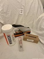 Group shot of wipes canister, stapler, cleaner tube, cloth kit box