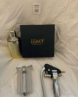 Group shot showing iiimy box, gold shaker, wine opener, vacuum pump