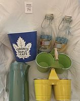 Group shot of all items: popcorn bucket, two milk bottles, green pitcher, metal pail caddy
