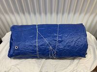 Rolled blue tarp on surface