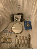 All items: clipper in bag, round mirror with arm, spa shower head package, TubShroom/SinkShroom package