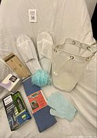 All items grouped: trimmer package, slippers, mesh caddy, towel, pouf, glove, boxes