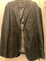 Front view of dark textured sport jacket on hanger