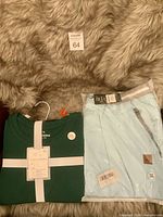 Pajama set folded with ribbon band beside packaged light blue shorts