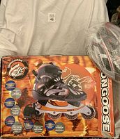 Box showing Mongoose inline skates and helmet beside it