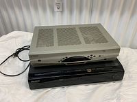 Front view of Rogers Explorer 3200 on top of Samsung Blu-ray/DVD player showing logos and front panels