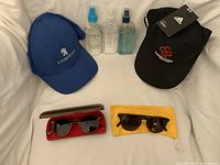All items overview: two caps, three cleaner bottles, two sunglasses displayed