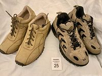 Both pairs of beige/tan women’s shoes side by side with lot card visible