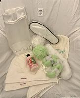 Full lot view showing slippers, towels, foaming bath, poufs, gloves, bag and scrubbers