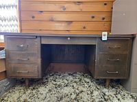 Front view of desk showing drawer layout and legs