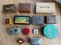 All thirteen trinket boxes arranged on wood surface