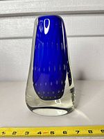 Front view showing cobalt blue core, bubble inclusions, and clear casing