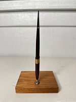 Full view of pen mounted in wood base