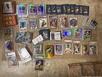 Overall lot showing graded slabs, Sportkings box, mini cards and assorted sleeved cards