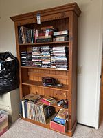Front view of full height wooden bookshelf with shelves