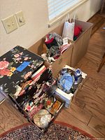 Overview showing floral sewing organizer box, cardboard boxes with Christmas decorations and sewing supplies