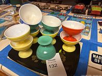 Group view of 10 multicolored footed glass dessert cups on tray