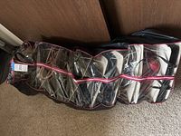 Exterior view of zippered storage rack showing clear vinyl pockets