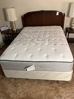 Overall view of mattress on foundation with headboard