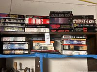 Overall view of two shelves filled with Stephen King and other hardcovers