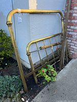 Headboard, footboard and side rails leaning against wall