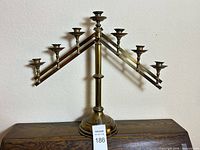Full view of brass tone seven-arm candelabra on base
