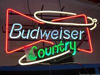 Full view of illuminated Budweiser Country neon sign