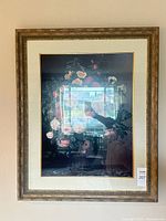 Full view of framed floral still life print hung on wall