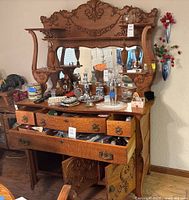 Full view of carved wood sideboard with mirror and open drawers