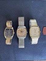 Three watches side by side showing overall design and condition