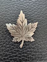 Front view of sterling silver maple leaf brooch