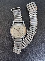 Full view of Marvin wristwatch with attached metal stretch bracelet